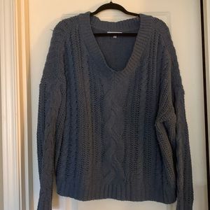 V-Neck cable knit sweater.